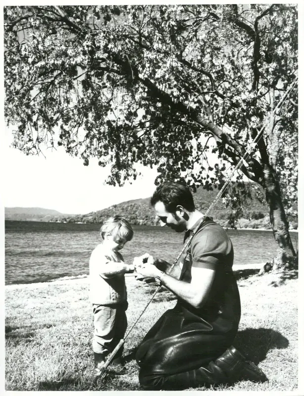 Adult and child preparing fishing gear at Motutere Bay, Lake Taupo